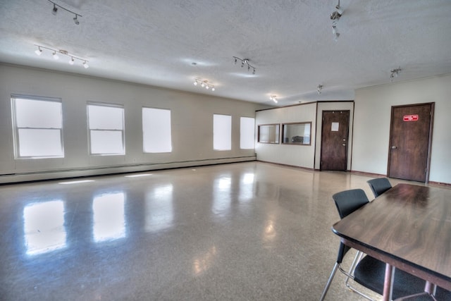 1133 Straight Creek Dr Unit 108, Dillon, CO 80435 - interior space featuring rail lighting, baseboard heating, and a textured ceiling