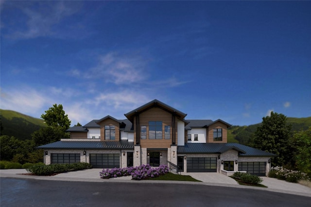 2410 Ski Trail Ln Unit 701, Steamboat Springs, CO 80487 - view of front of property featuring a standing seam roof, driveway, metal roof, and a garage