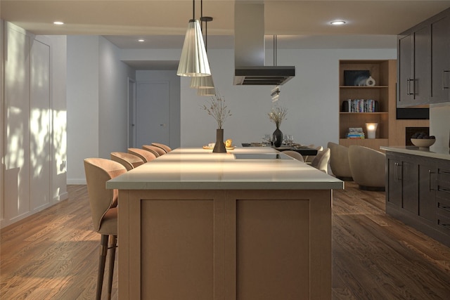 2410 Ski Trail Ln Unit 701, Steamboat Springs, CO 80487 - kitchen with a breakfast bar area, a center island, island range hood, and dark wood-style flooring