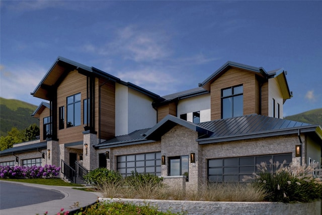 2410 Ski Trail Ln Unit 701, Steamboat Springs, CO 80487 - contemporary house with a garage, stone siding, a standing seam roof, and metal roof
