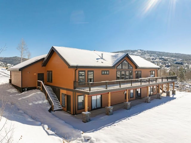 snow covered house with stairway