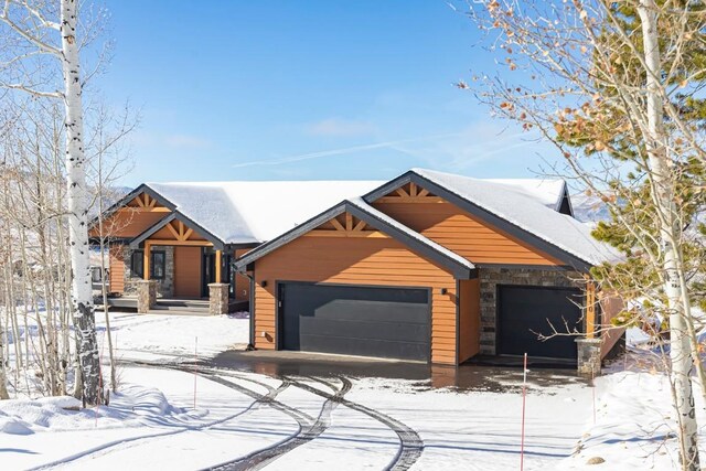 1110 Mt Neva Dr, Granby, CO 80446 - rustic home featuring an attached garage and stone siding