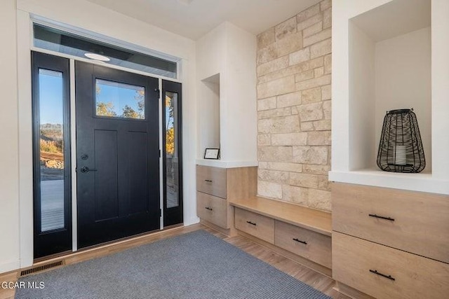 mudroom with visible vents and wood finished floors