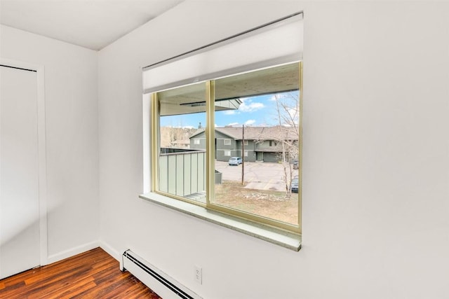empty room featuring baseboards and dark wood-style floors