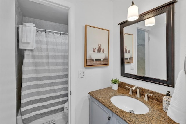 bathroom with toilet, a shower with shower curtain, and vanity