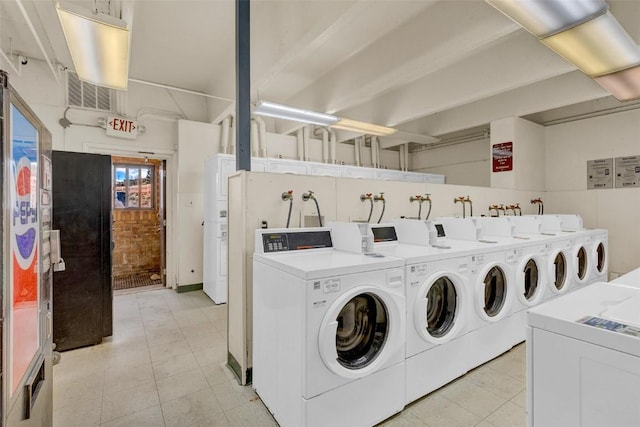 common laundry area featuring light tile patterned flooring and washer and dryer