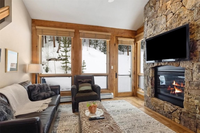 129 Tip Top Trl Unit 6543, Keystone, CO 80435 - living area with baseboard heating, vaulted ceiling, wood finished floors, and a fireplace