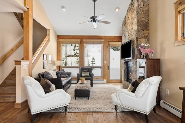 129 Tip Top Trl Unit 6543, Keystone, CO 80435 - living area with baseboard heating, stairway, a stone fireplace, hardwood / wood-style floors, and ceiling fan
