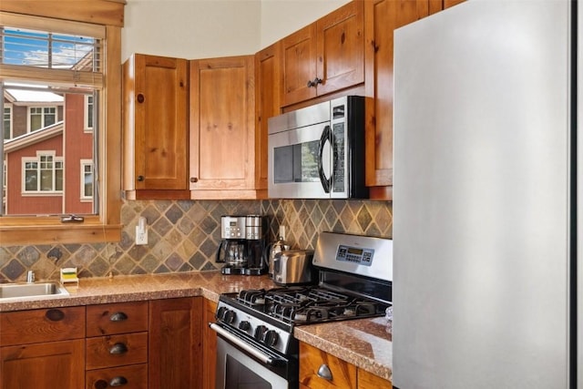 129 Tip Top Trl Unit 6543, Keystone, CO 80435 - kitchen featuring brown cabinets, appliances with stainless steel finishes, decorative backsplash, and a sink