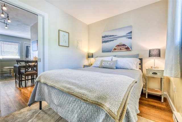 3295 Apres Ski Way Unit B10, Steamboat Springs, CO 80487 - bedroom featuring wood finished floors, track lighting, and baseboard heating