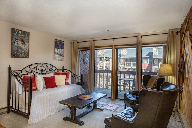 bedroom with access to exterior, carpet flooring, and baseboards