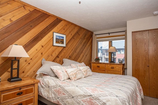 carpeted bedroom featuring wood walls