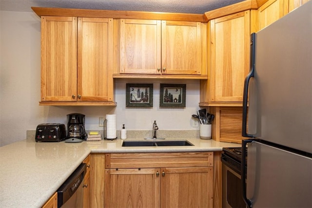kitchen with stainless steel appliances, light countertops, and a sink