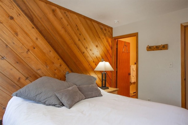 bedroom featuring wooden walls