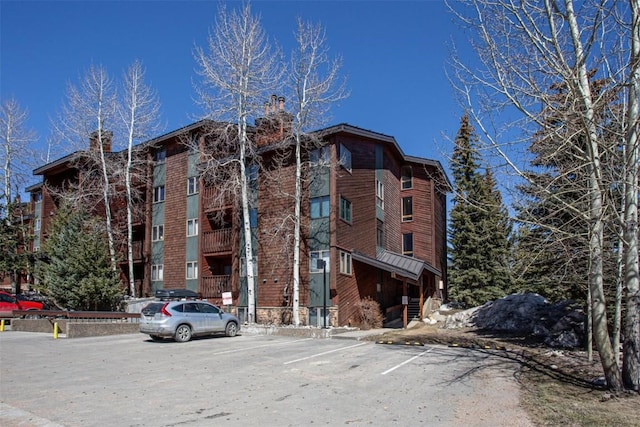 view of property featuring uncovered parking