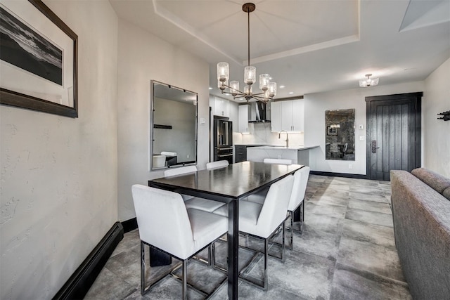 1891 Ski Hill Rd Unit 7404, Breckenridge, CO 80424 - dining space with a raised ceiling, baseboards, and a chandelier