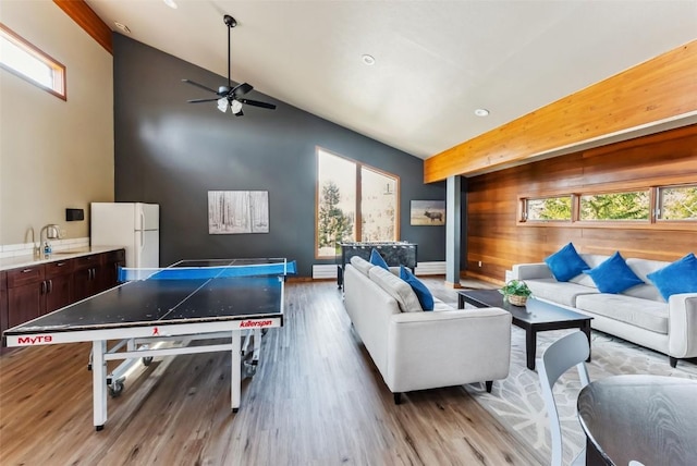 9460 Ryan Gulch Rd Unit 65, Silverthorne, CO 80498 - playroom featuring a sink, high vaulted ceiling, a ceiling fan, light wood-style flooring, and wood walls