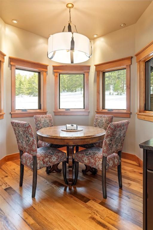 174 Sage Dr, Breckenridge, CO 80424 - dining area with light wood-style floors, baseboards, and a healthy amount of sunlight
