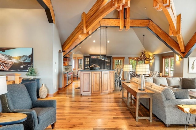 174 Sage Dr, Breckenridge, CO 80424 - living area with high vaulted ceiling, beamed ceiling, light wood-type flooring, and a chandelier