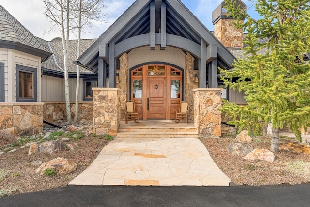 174 Sage Dr, Breckenridge, CO 80424 - entrance to property with roof with shingles, a chimney, and stone siding