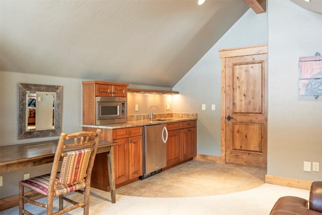 174 Sage Dr, Breckenridge, CO 80424 - kitchen featuring brown cabinets, lofted ceiling with beams, a sink, stainless steel appliances, and baseboards