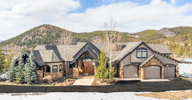 174 Sage Dr, Breckenridge, CO 80424 - view of front of property featuring aphalt driveway, a mountain view, and stone siding