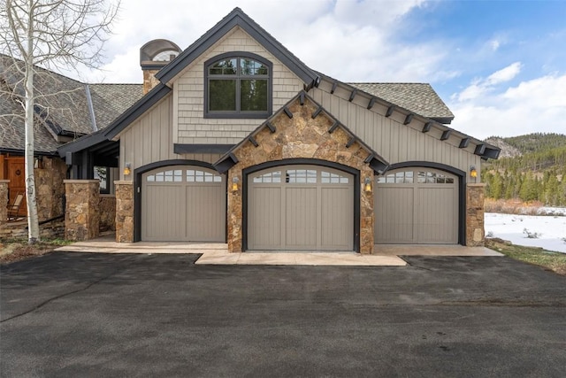 174 Sage Dr, Breckenridge, CO 80424 - craftsman inspired home with a chimney, a shingled roof, aphalt driveway, and stone siding
