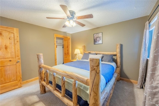 carpeted bedroom featuring baseboards, a textured ceiling, and ceiling fan