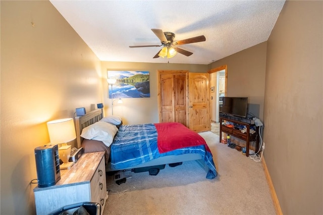bedroom with ceiling fan, light carpet, and baseboards