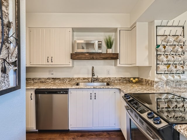 111 Corinthian Cir Unit A, Dillon, CO 80435 - kitchen with appliances with stainless steel finishes, a sink, white cabinets, light stone countertops, and dark wood-type flooring