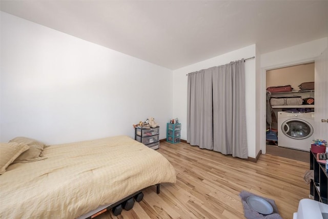 14 Redwood Ct Unit 14, Steamboat Springs, CO 80487 - bedroom with washer / clothes dryer and light wood-type flooring