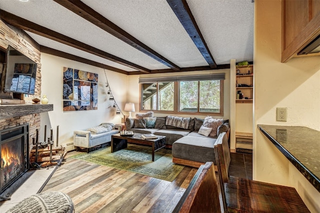 311 S High St Unit 108, Breckenridge, CO 80424 - living room with a textured ceiling, beam ceiling, a fireplace, wood finished floors, and baseboards