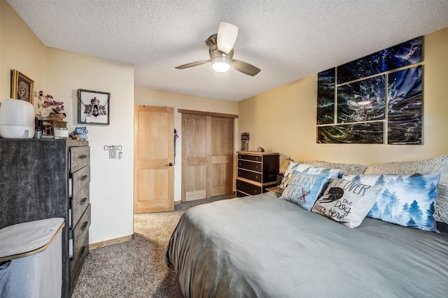 311 S High St Unit 108, Breckenridge, CO 80424 - carpeted bedroom featuring a closet, a textured ceiling, a ceiling fan, and baseboards