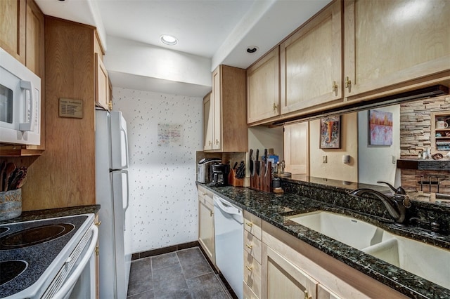 311 S High St Unit 108, Breckenridge, CO 80424 - kitchen with white appliances, a sink, dark stone countertops, and baseboards