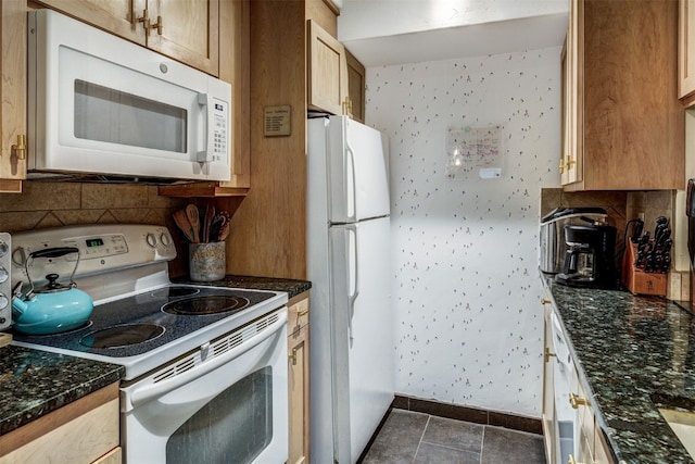 311 S High St Unit 108, Breckenridge, CO 80424 - kitchen featuring white appliances, baseboards, tasteful backsplash, and dark stone counters