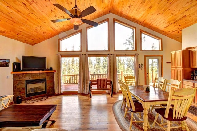 103 War Pony Way, Como, CO 80432 - dining room with wood ceiling, healthy amount of natural light, a stone fireplace, light wood finished floors, and ceiling fan