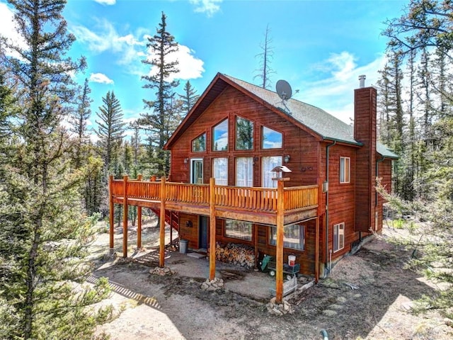 103 War Pony Way, Como, CO 80432 - back of property with a chimney, a deck, and a patio
