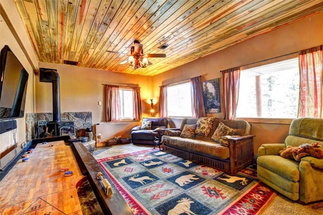 103 War Pony Way, Como, CO 80432 - living room featuring healthy amount of natural light, wooden ceiling, a wood stove, and a ceiling fan