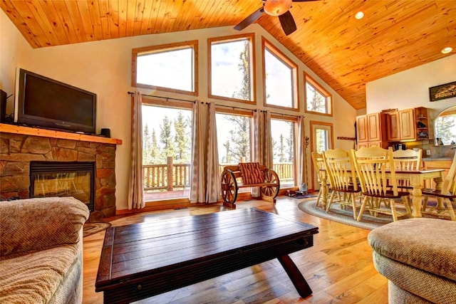 103 War Pony Way, Como, CO 80432 - living area with high vaulted ceiling, ceiling fan, wooden ceiling, a fireplace, and light wood-style floors