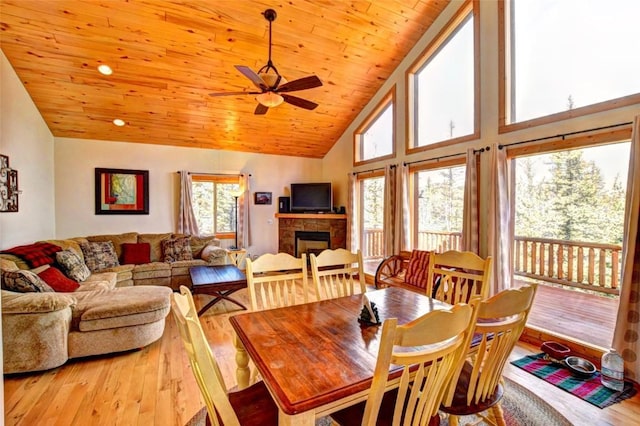 103 War Pony Way, Como, CO 80432 - dining room featuring a fireplace, wood finished floors, a ceiling fan, high vaulted ceiling, and wooden ceiling