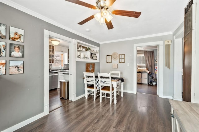 609 E Jefferson Ave, Hayden, CO 81639 - dining space with a ceiling fan, ornamental molding, dark wood-style floors, and baseboards