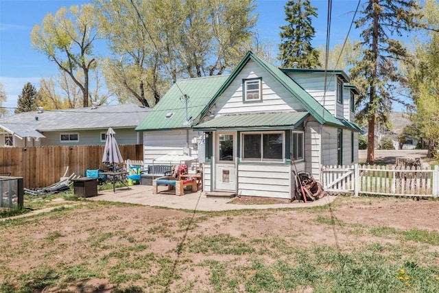 609 E Jefferson Ave, Hayden, CO 81639 - rear view of house featuring a fenced backyard, a patio, and metal roof