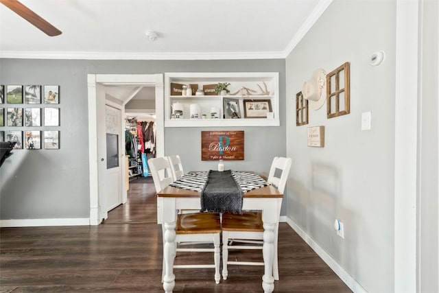 609 E Jefferson Ave, Hayden, CO 81639 - dining area featuring crown molding, dark wood-style flooring, baseboards, and built in shelves