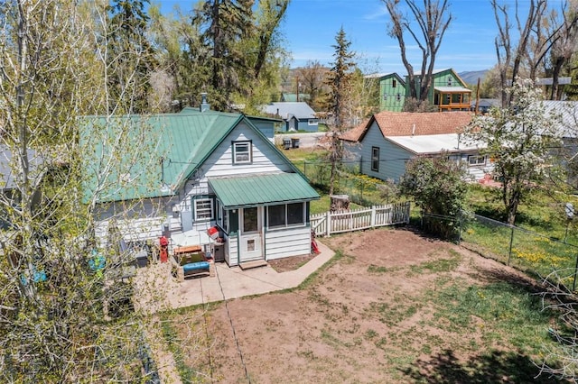 609 E Jefferson Ave, Hayden, CO 81639 - rear view of property with a fenced backyard, a patio, and metal roof
