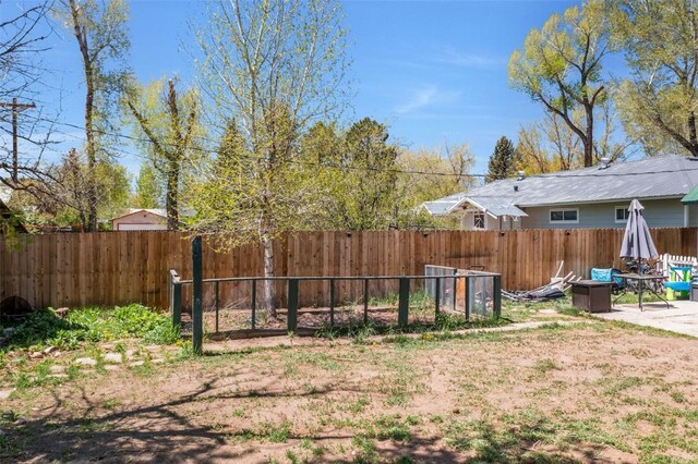 609 E Jefferson Ave, Hayden, CO 81639 - snow covered rear of property with a trampoline, fence, and metal roof