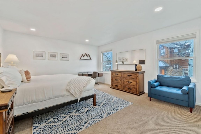bedroom with light colored carpet, recessed lighting, and baseboards