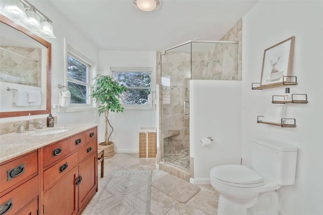bathroom with vanity, tile patterned flooring, a stall shower, and toilet