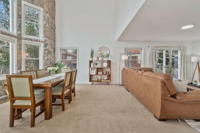 living room featuring a high ceiling and light carpet