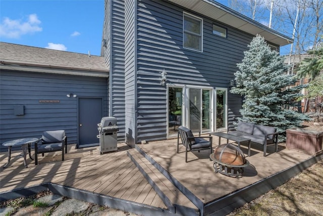 back of property featuring an outdoor living space with a fire pit and a wooden deck