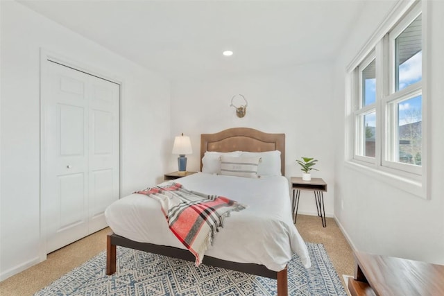carpeted bedroom featuring baseboards and recessed lighting